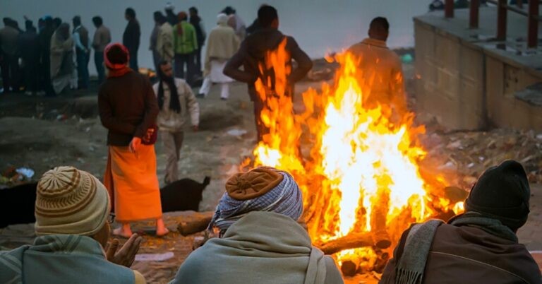 An Indian woman wakes up moments before her cremation.